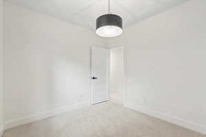 Carpeted empty room featuring baseboards