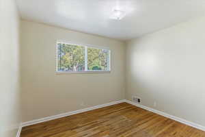 Empty room with wood finished floors and baseboards