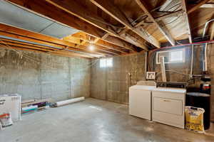 Basement featuring a water softener system and washer and dryer