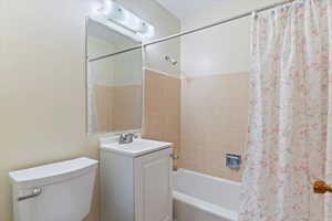 Bathroom with shower / bath combo and vanity