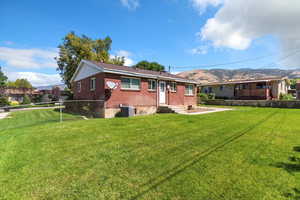 Back of house with brick siding and a mountain view