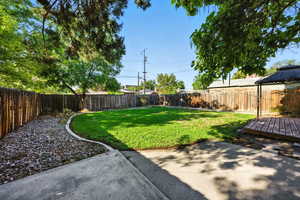 Fenced backyard featuring a gazebo, a patio area, and a wooden deck