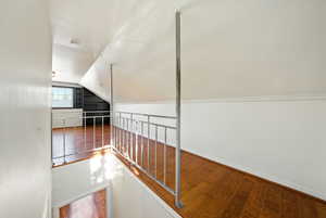 Bonus room featuring hardwood / wood-style floors and vaulted ceiling