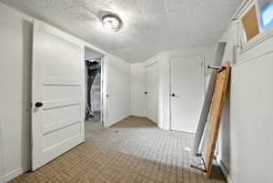 Bonus room featuring light colored carpet and baseboards
