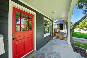 View of exterior entry featuring covered porch