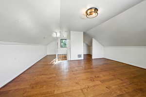 Additional living space with wood-type flooring and lofted ceiling
