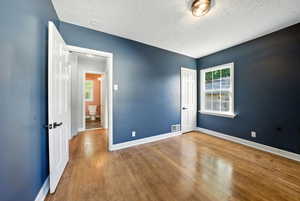 Empty room with baseboards and wood finished floors