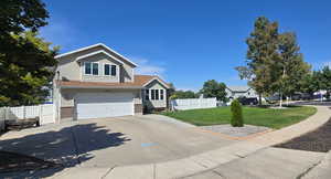 View of front facade featuring driveway, an attached garage, and brick siding