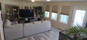 Living area featuring baseboards and wood finished floors