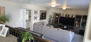 Carpeted living room with a textured ceiling