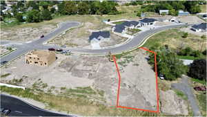 Aerial view of property's location with property parcel outlined and nearby suburban area