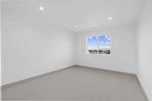 Empty room featuring carpet flooring and recessed lighting