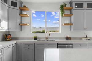 Kitchen featuring glass insert cabinets, open shelves, and gray cabinets