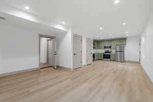 Unfurnished living room featuring recessed lighting and light wood-style flooring