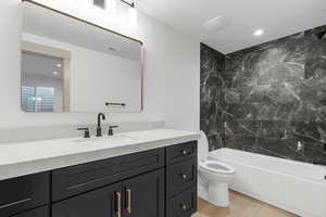 Full bathroom with shower / washtub combination, vanity, recessed lighting, light wood-style floors, and a textured ceiling