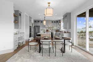 Dining space with light wood finished floors and recessed lighting
