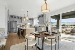 Dining space featuring light wood-style flooring, recessed lighting, and a mountain view