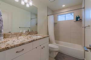 Bathroom featuring shower / tub combo with curtain, vanity, light tile patterned floors, and recessed lighting
