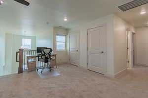 Carpeted office featuring a chandelier and recessed lighting
