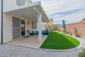 Fenced backyard with a patio and an outdoor living space