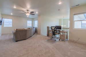 Office space with light colored carpet, ceiling fan, a chandelier, and recessed lighting