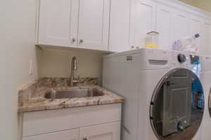 Laundry area with cabinet space and washer and dryer