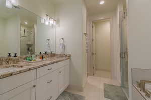 Full bathroom with light tile patterned flooring, double vanity, a stall shower, and recessed lighting