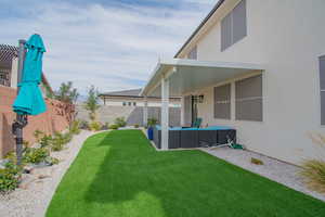 Fenced backyard featuring a patio area and an outdoor hangout area