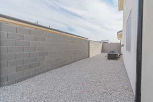 View of property exterior featuring a fenced backyard and a central air condition unit