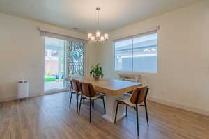 Dining space featuring light wood-style flooring and a chandelier