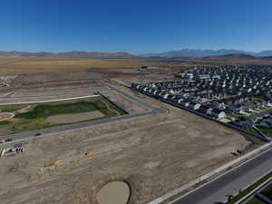 Aerial view of property's location featuring nearby suburban area and a mountain backdrop