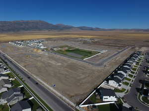 Aerial view of property's location with nearby suburban area and a mountainous background