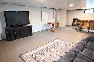 Living room featuring concrete flooring and a dry bar