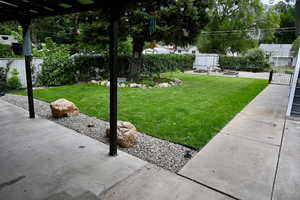 Fenced backyard featuring an outbuilding
