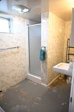 Bathroom featuring a stall shower and concrete floors