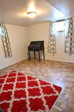 Basement with brick patterned floors and baseboards