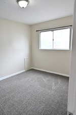 Carpeted empty room featuring plenty of natural light