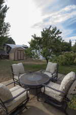 View of patio with a storage shed