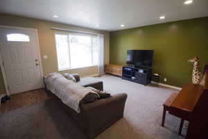Living area featuring recessed lighting and carpet floors