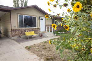 View of exterior entry featuring stucco siding and brick siding