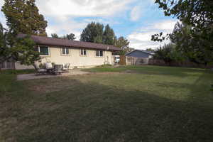 Back of property featuring a patio and stucco siding