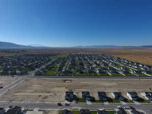 Aerial view of property's location with nearby suburban area and a mountain backdrop