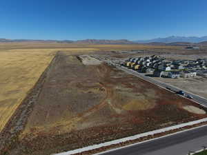 View of rural area with nearby suburban area and a mountain backdrop