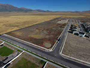 Aerial view of property and surrounding area featuring mountains and rural landscape