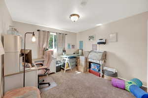 Carpeted office space featuring baseboards