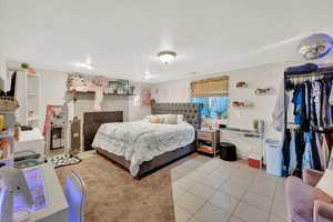 Bedroom with tile patterned floors and a closet