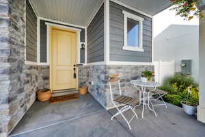 Property entrance featuring stone siding