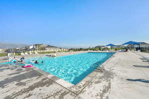 Community pool featuring a residential view and a patio