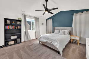 Bedroom with carpet floors, lofted ceiling, and a ceiling fan