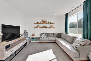 Carpeted living room featuring recessed lighting